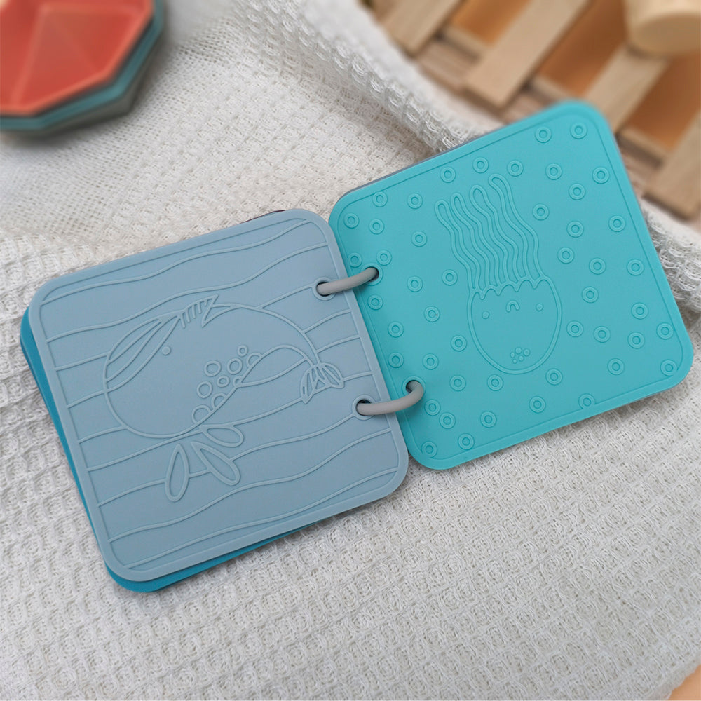 Two blue textured coasters with embossed designs on a textured surface.