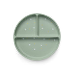 A green silicone divider plate with suction base and white polka dots.