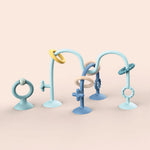 Set of blue and beige baby teething rings on a beige background