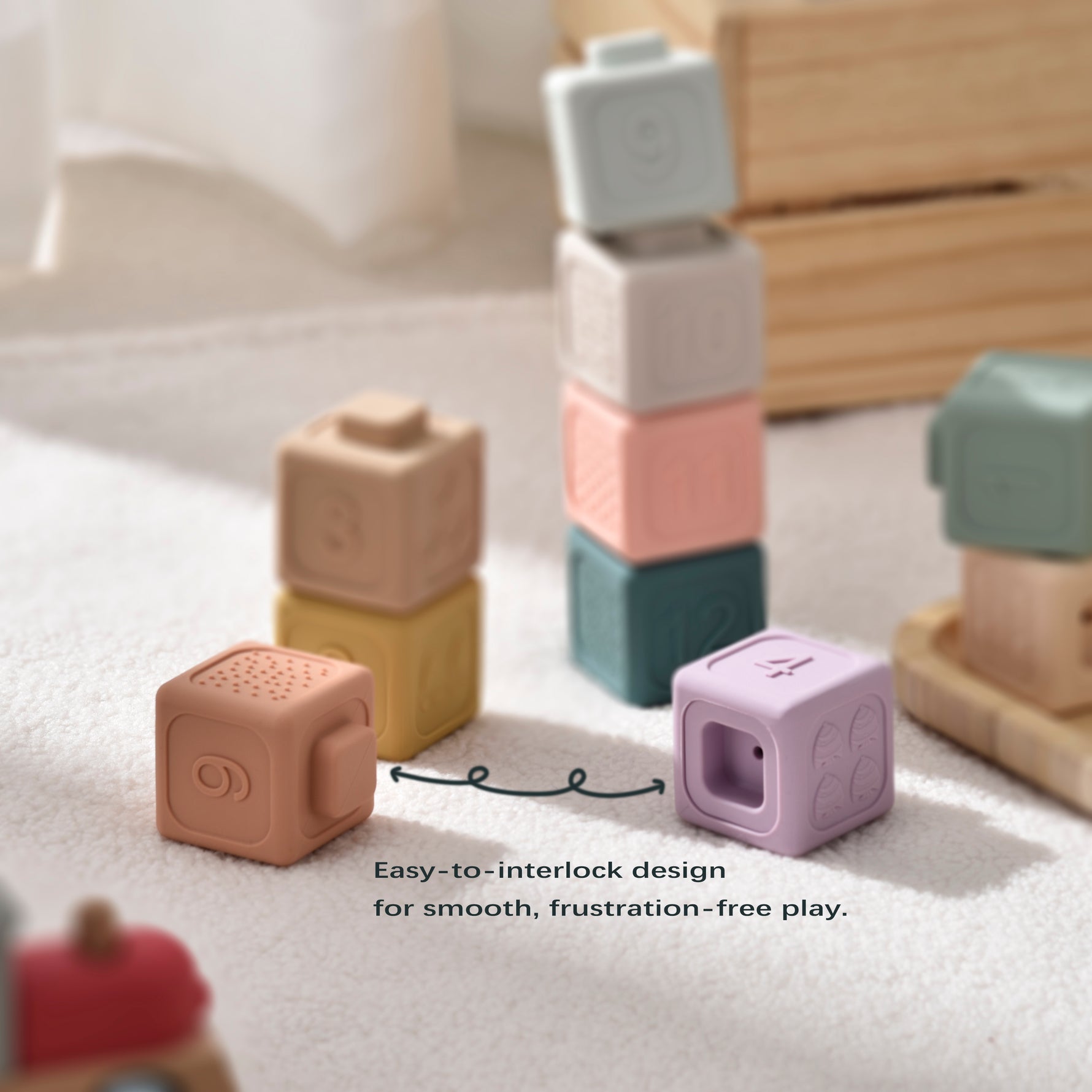 Colorful interlocking toy blocks on a light surface with text about easy-to-interlock design.