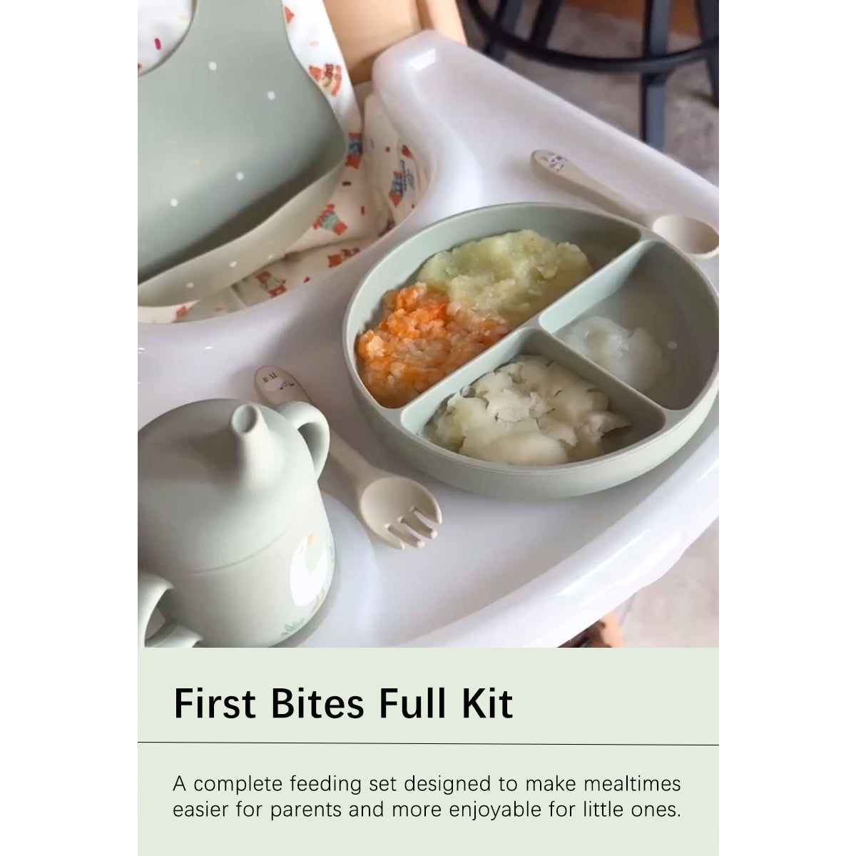 A baby feeding set displayed on a high chair tray, including a divided plate with food, a small teapot, spoons, and a bib. Text at the bottom reads 'First Bites Full Kit' with a descriptive subtitle.