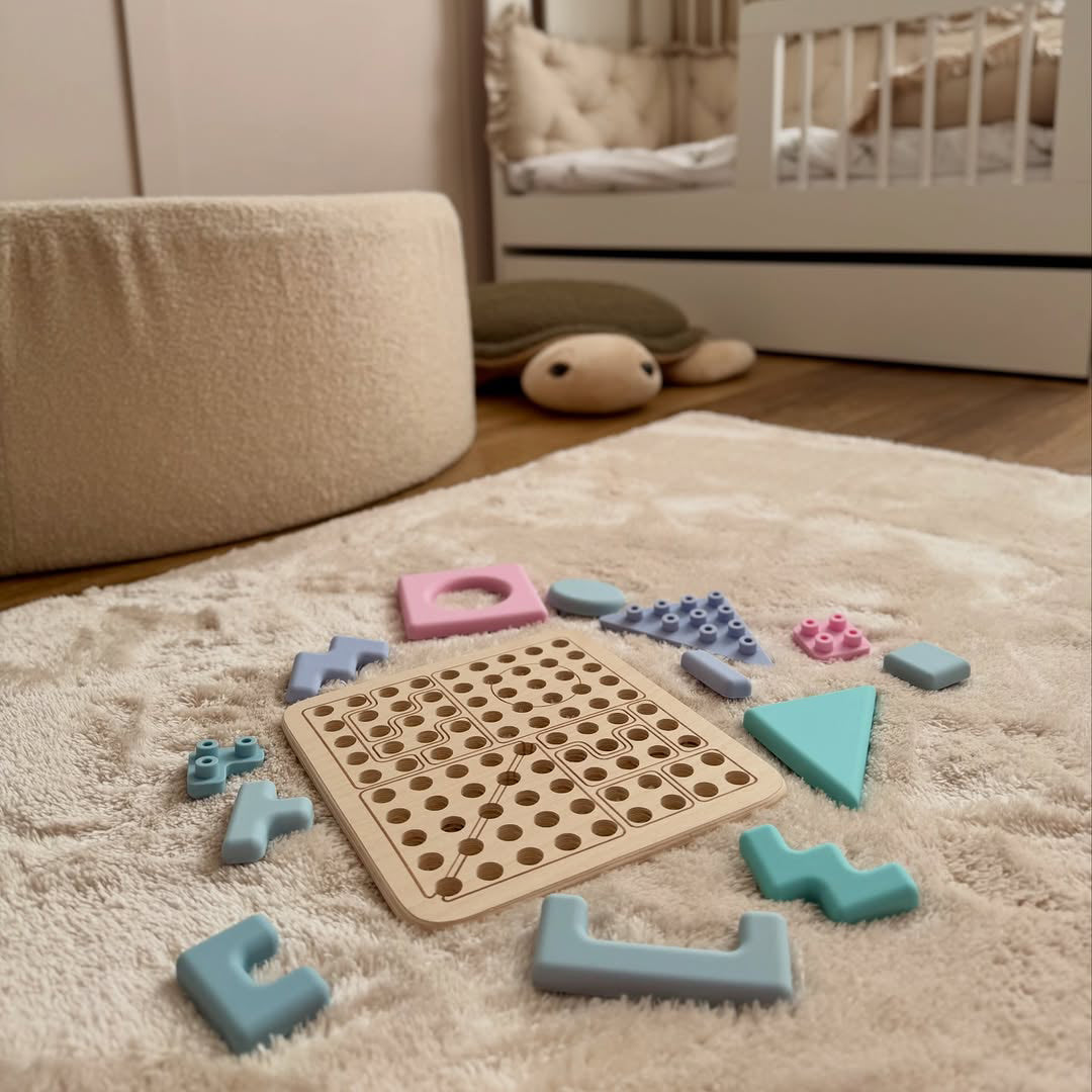 Wooden puzzle with colorful interlocking pieces on a carpeted floor. 