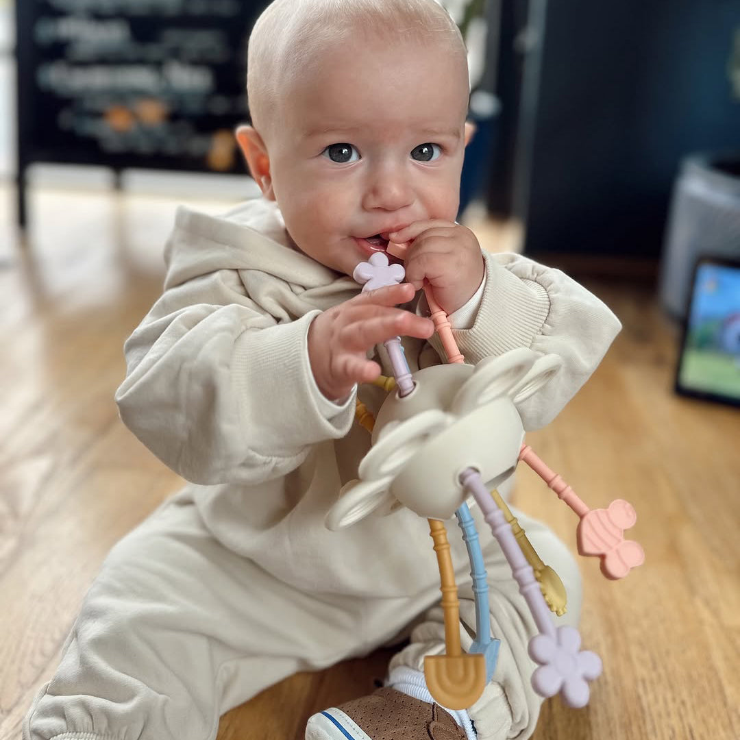 Baby playing with a toy in a home setting