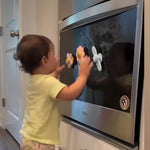 Child playing with magnets on a refrigerator door 