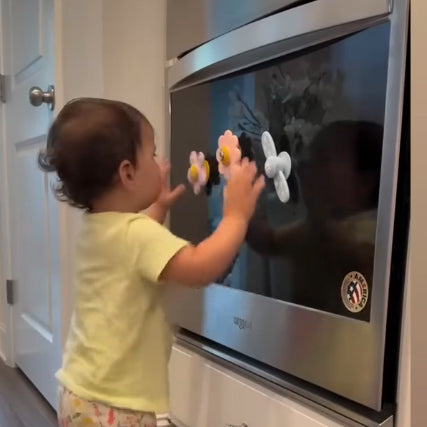 Child playing with magnets on a refrigerator door 