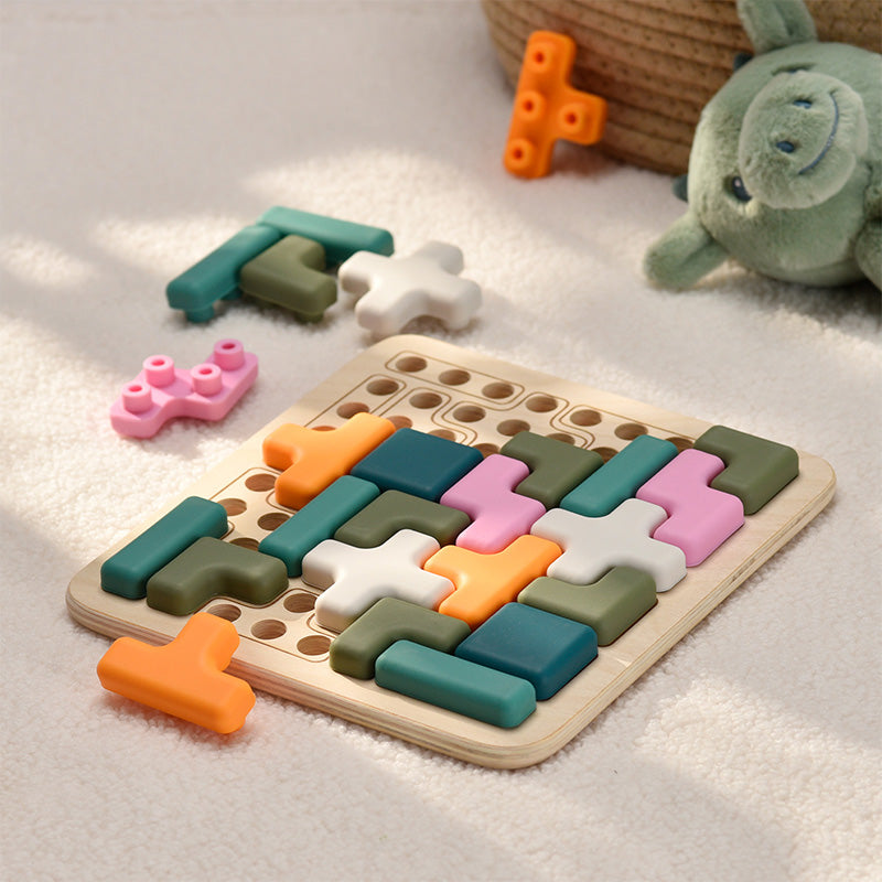 Colorful wooden puzzle toy on a soft surface with a plush turtle toy in the background. 