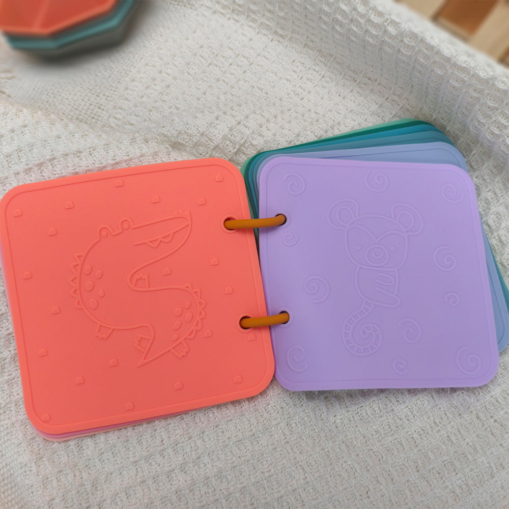 Colorful children's books with embossed designs on a textured surface 