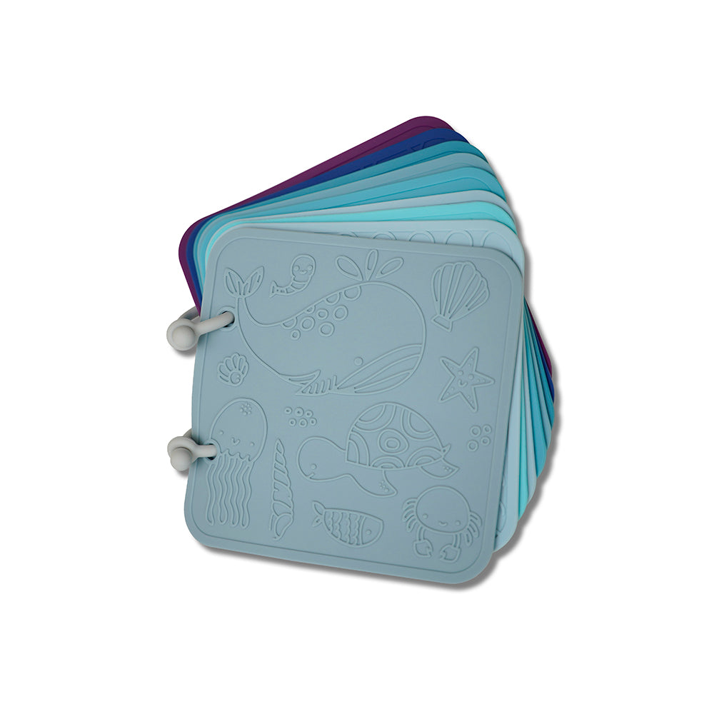 Stack of colorful silicone coasters with sea-themed designs on a white background 