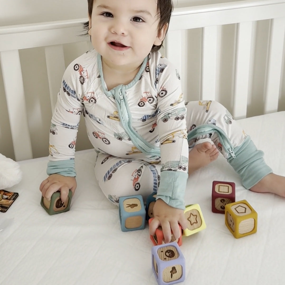 Child playing with blocks in a crib