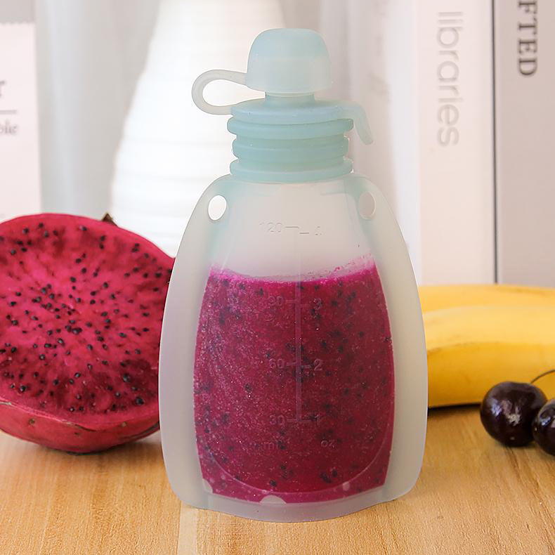 Silicone water bottle with dragon fruit and banana on a wooden surface 
