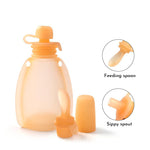 Baby bottle with feeding spoon and sippy spout on a white background 