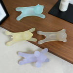 Four silicone bear-shaped desk organizers on a wooden surface.
