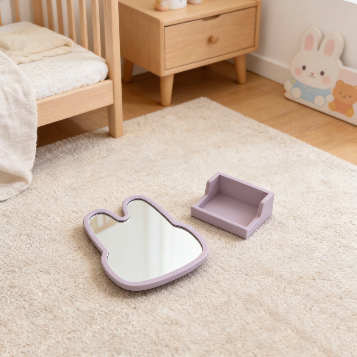 Children's room with a bunny-shaped mirror and tray on the floor. 