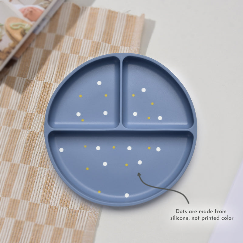 Blue silicone plate with white and yellow dots on a checkered tablecloth 
