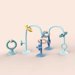 Set of blue and beige baby teething rings on a beige background