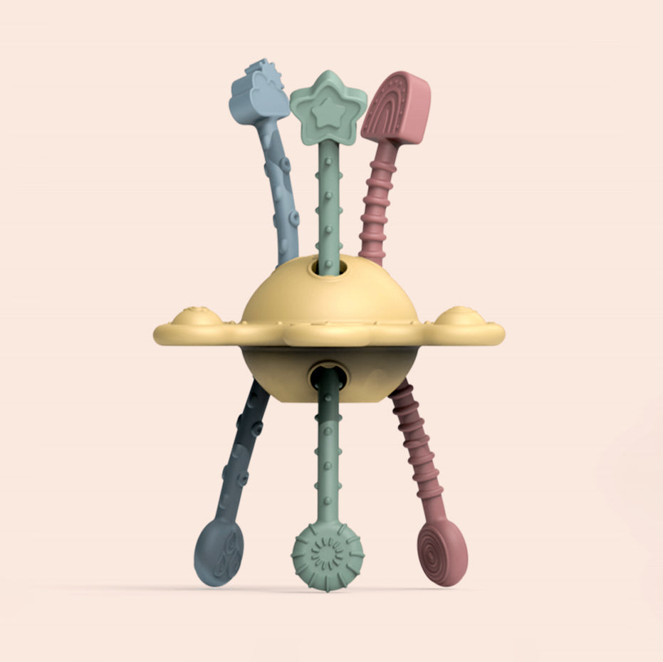 Colorful baby teething toy with multiple textures on a beige background